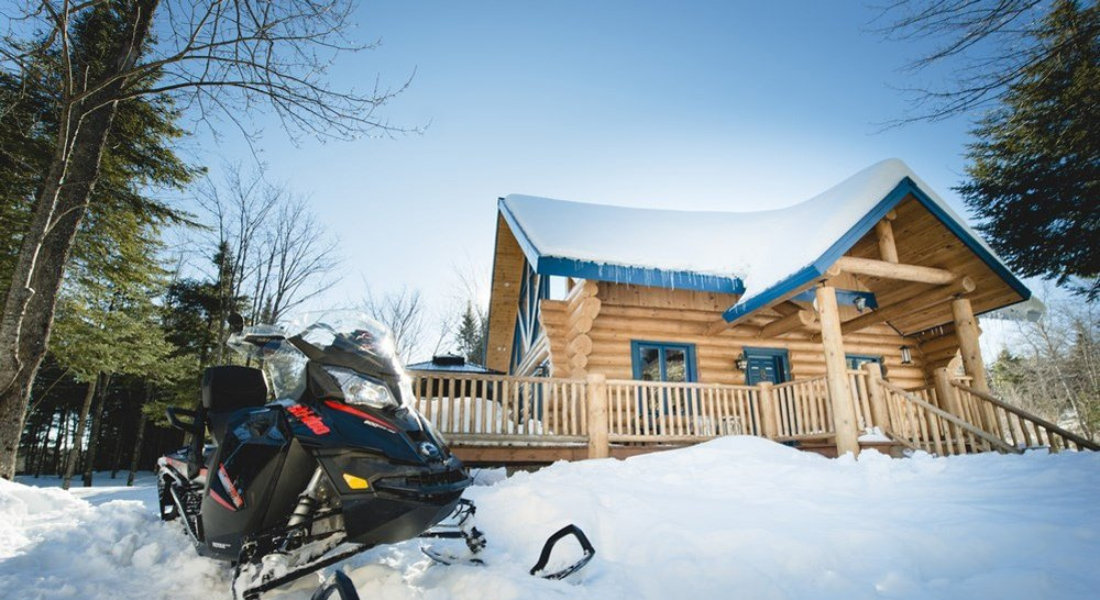 quebec snowmobile Traditional chalet and snowmobile