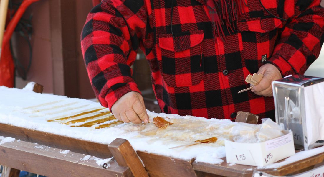 Taffy on snow Man at the sugar shack in Québec