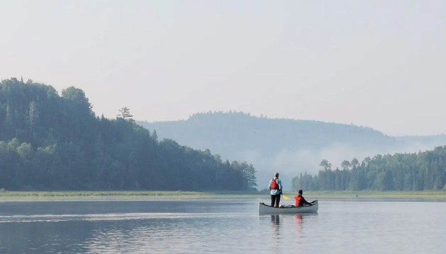 Canoeing in Mauricie Canoeing on a lake surrounded by forest in Mauricie, Quebec.