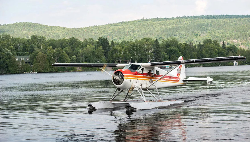 Mauricie by seaplane A seaplane on a lake surrounded by forests in Mauricie, Quebec.