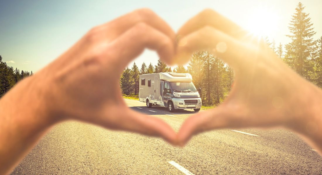 The advantages of choosing a comparison tool Hands forming a heart with an RV on the road in the background
