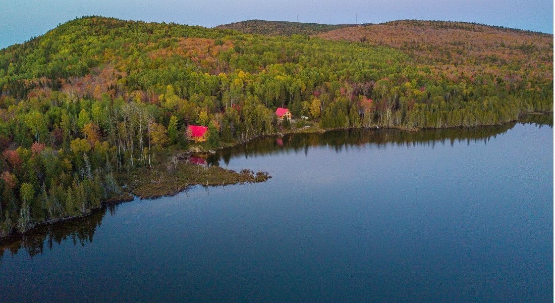 Aerial view of a cabin in Quebec by a lake