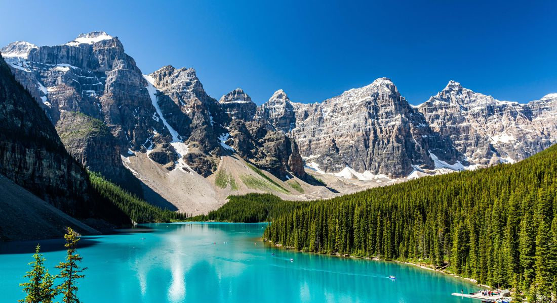 Les eaux bleu émeraude du lac Moraine avec les montagnes en fond