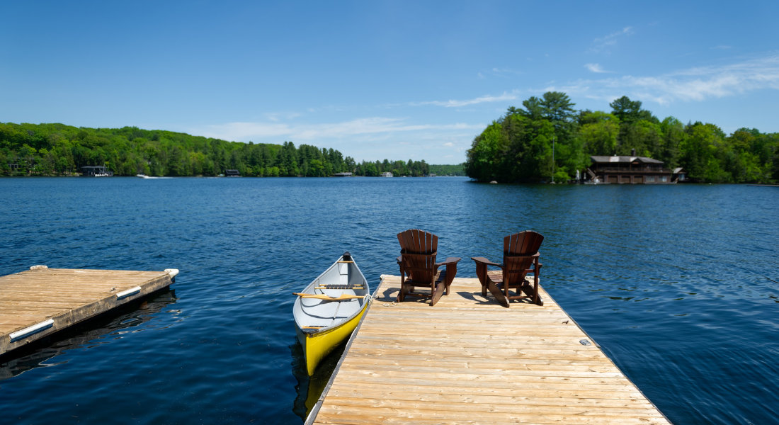 Muskoka attire les célébrités en quête de calme et d'intimité quai avec chaises adirondak et canot à Muskoka en Ontario