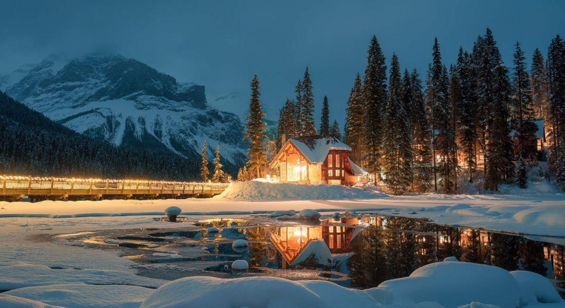 Visiting Yoho National Park Chalet lit up at night in Yoho Park under the snow