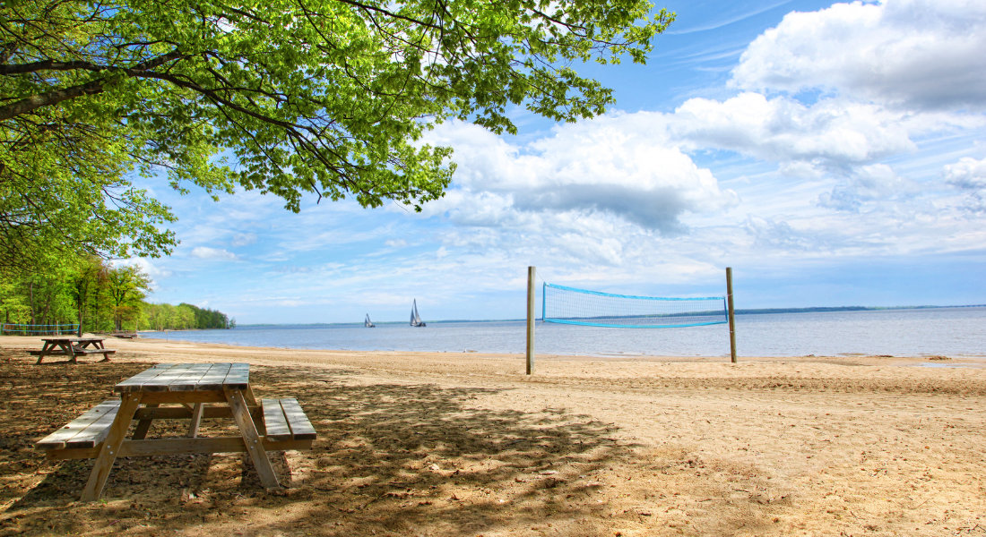 Beach at Oka National Park with a volleyball net and a picnic table