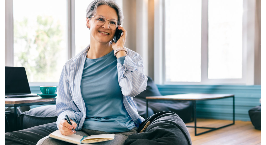 Asking your travel agent the right questions Woman on the phone taking notes in a notebook