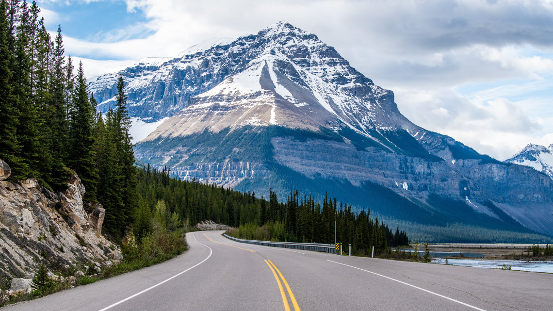 Icefields Parkway road crossing mountainous landscapes.