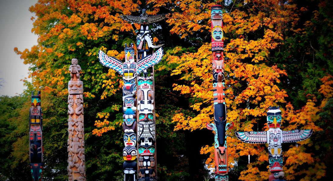 Totems amérindiens avec des arbres en fond