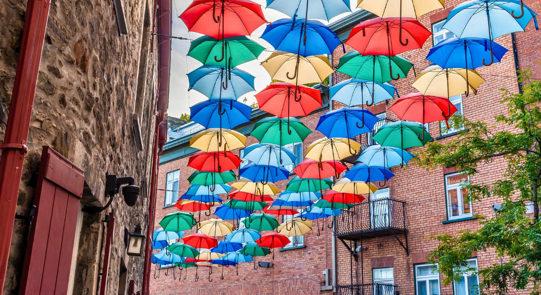 An alleyway below Quebec City decorated with colorful umbrellas