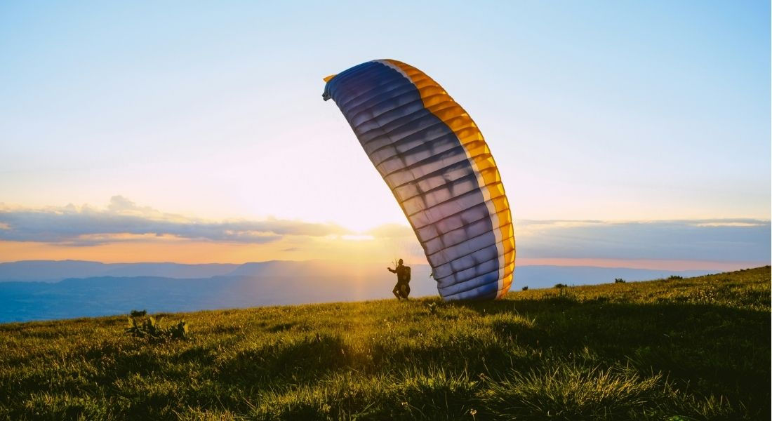 Vol en parapente au Québec Personne s'apprétant à faire un vol en parapente au coucher du soleil