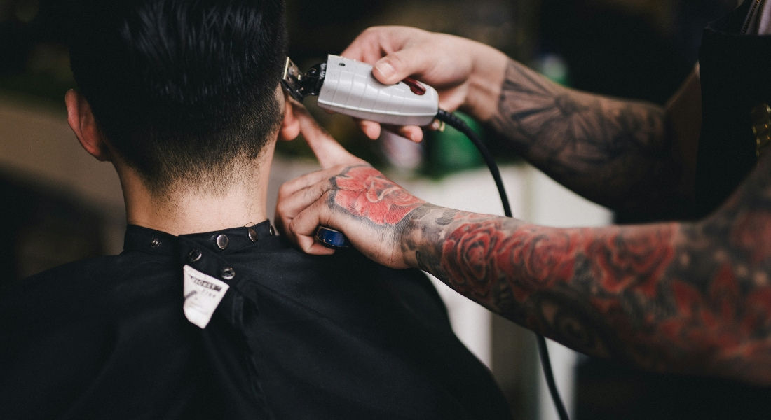 How Much to Tip in Canada Barber performing a haircut on a man