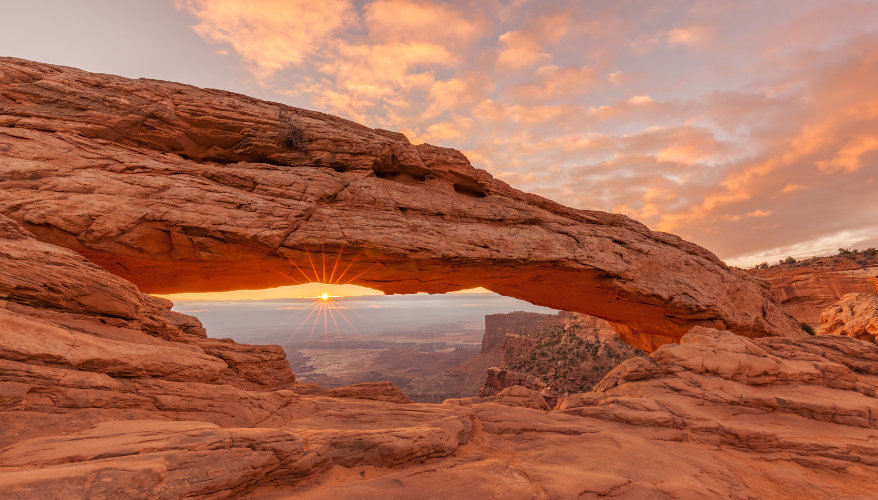 Mesa Arch A view of the arch framing the sunset.