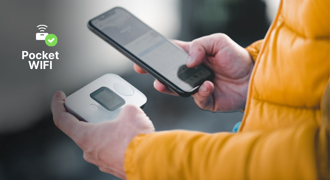 Close-up of a pocket Wi-Fi device and a phone, enabling multiple devices to connect while travelling.