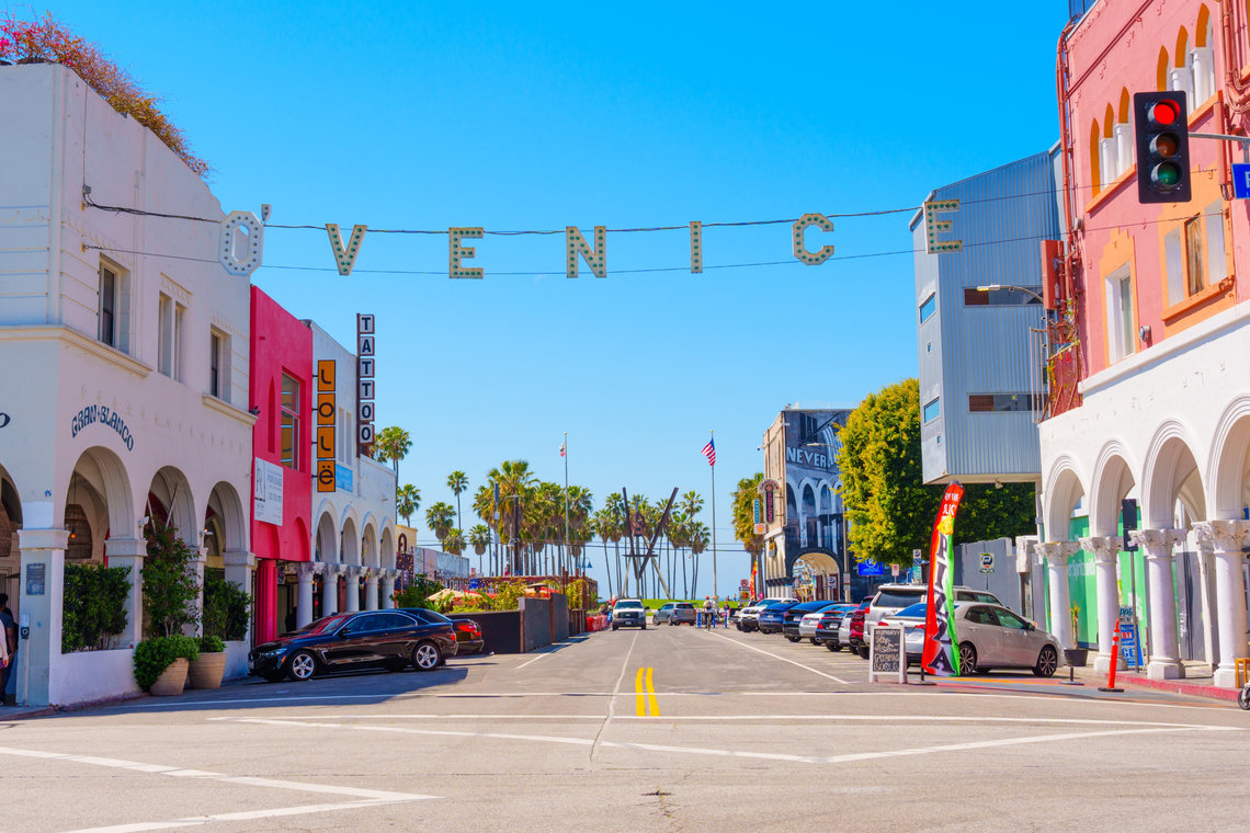 Venice Beach Venice sign above a street leading to Venice Beach in California
