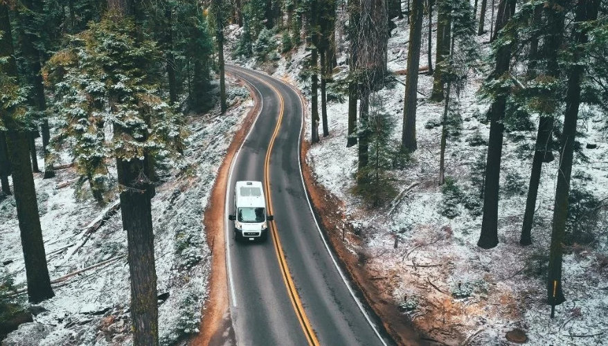 Car or motorhome? Car driving on a snowy road