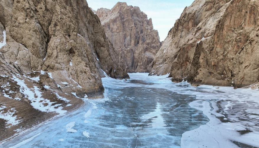 Frozen canyon in the American West Partially frozen river between high rock walls in a winter canyon