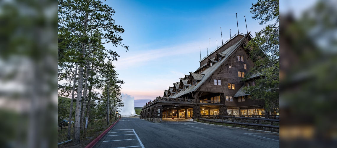 Old Faithful Inn, with the geyser on the background