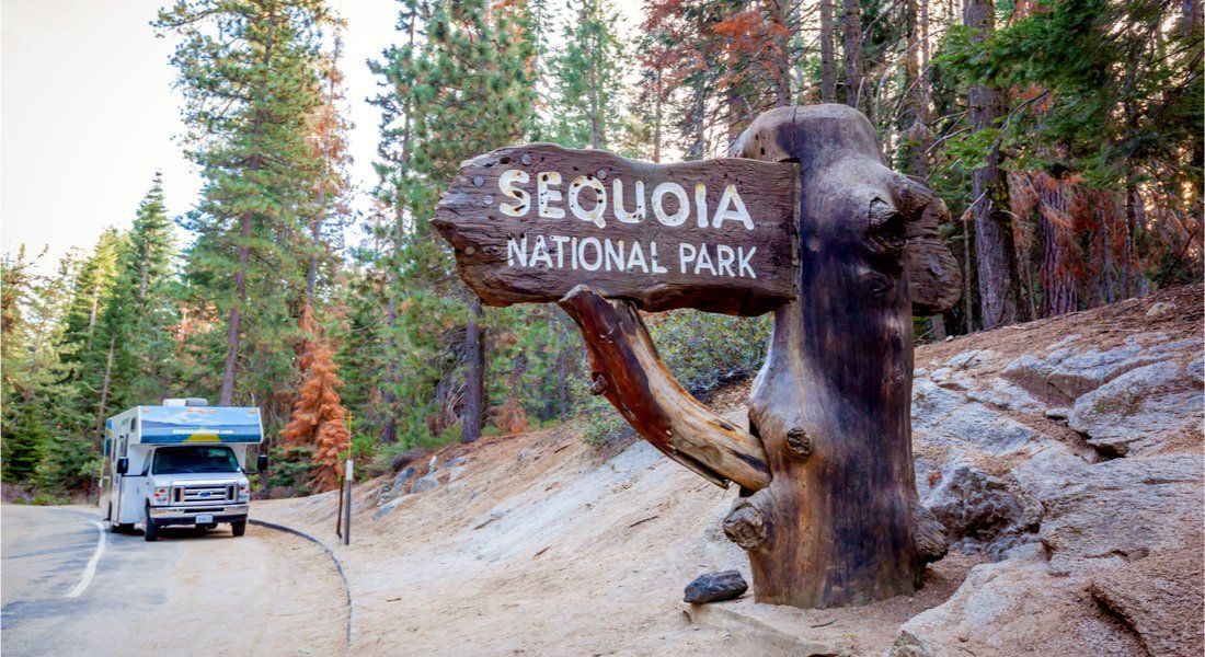 @JHVEPhoto - shutterstock-789468280 RV in front of the entrance to Sequoia Park
